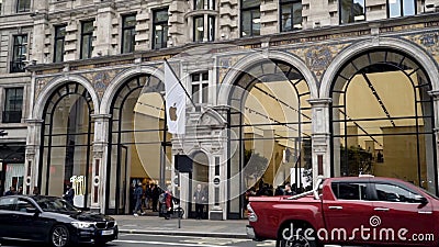 London, Britain-September, 2019: Apple store is located in old architectural building of European city. Action. Walking Editorial Stock Photo