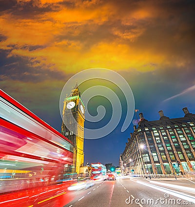 London. City night scene with red bus crossing Westminster. Traffic light trails Stock Photo
