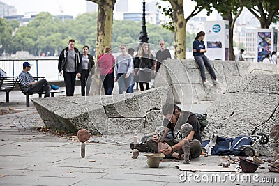 Man makes sculptures of stones on the waterfront Editorial Stock Photo