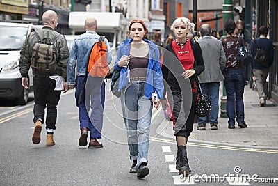 Two fashionable blonde girls walk past Brick Lane Editorial Stock Photo