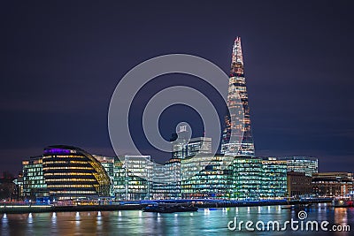 London, England - City Hall of London and offices with famous Shard skyscraper by night Stock Photo