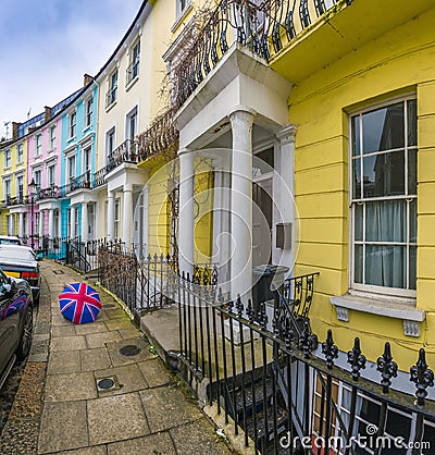 London, England - Colorful Victorian houses of Primrose hill with british style umbrella Stock Photo