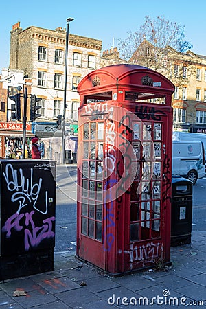 London, England â€“ December 2022. Classic, retro red phone booth. London's vintage red phone boxes in Punk version Editorial Stock Photo