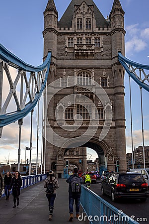 LONDON, ENGLAND, DECEMBER 10th, 2018: People crossing ower Bridge in London, the UK. English symbols. Seen from the Editorial Stock Photo