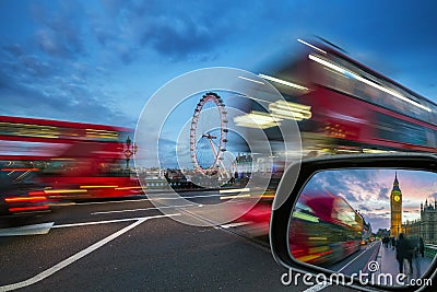 London, England - iconic red double-decker buses on the move on Westminster Bridge with Big Ben and Houses of Parliament Editorial Stock Photo