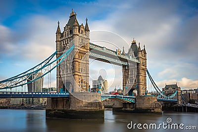 London, England - Iconic Tower Bridge with traditional red double-decker bus and skyscrapers of Bank District Stock Photo
