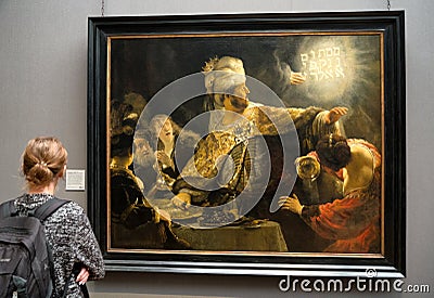 Visitor looking at painting of Rembrandt in National galleryin London Editorial Stock Photo