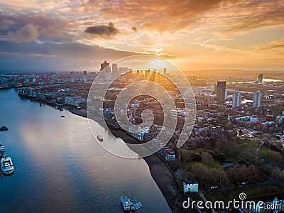 London, England - Panoramic aerial skyline view of east London at sunrise with skycrapers of Canary Wharf Stock Photo