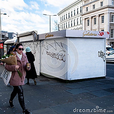 Woman Walking Carrying Takeaway Coffee And Bouquet Of Flowers Editorial Stock Photo
