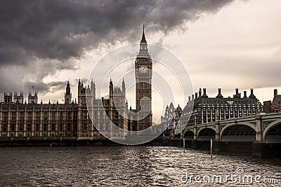 London, UK - The Houses of Parliament, the Big Ben and Westminster Bridge under dark clouds Stock Photo