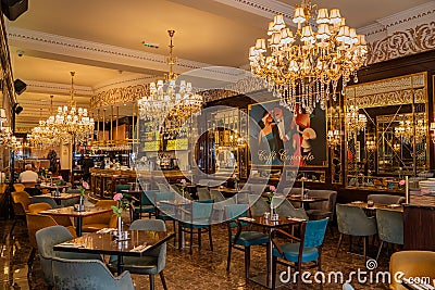 London: Inside upscale Cafe Concerto in Covent Garden with beautiful chandeliers and paintings Editorial Stock Photo