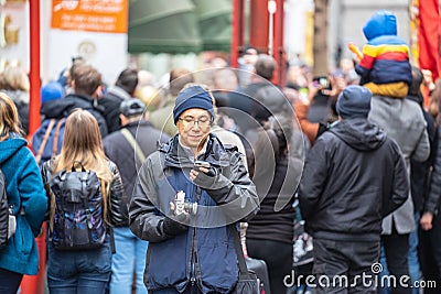 London, January 26, 2020. Photographer taking photos in London Chinatown. Chinese New Year Celebrations. Selective focus Editorial Stock Photo