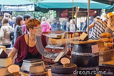 LONDON - JUN 12, 2015: Unidentified visitors at a Cheese stall at Borough Market. Borough Market is the largest gourmet food Editorial Stock Photo