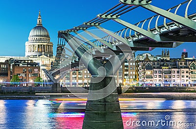 LONDON - JUNE 15, 2015: City night skyline with St Paul Cathedral and Millennium Bridge. London attracts 50 million people annual Editorial Stock Photo