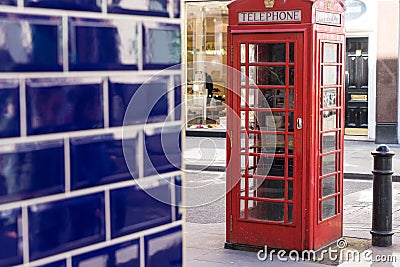 London - March 30: Iconic telephone booth with blue tile wall on March 30, 2017 Editorial Stock Photo