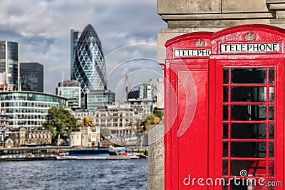 London symbols with red PHONE BOOTHS against modern architecture in England Stock Photo