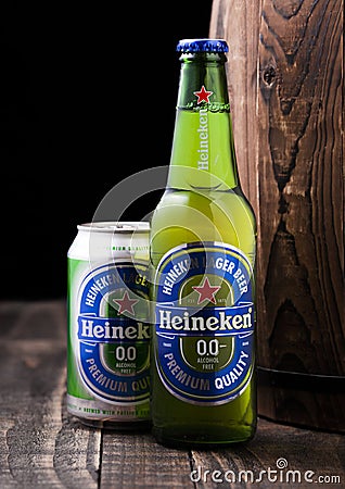 LONDON, UK - APRIL 27, 2018: Bottle and aluminium can of Heineken Alcohol free Lager Beer next to wooden barrel Editorial Stock Photo