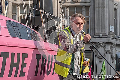 London, UK - April 15, 2019: Extinction Rebellion campaigners spokesman gave speech on a a pink boat in blocked Oxford Circus Editorial Stock Photo