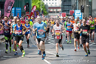 Lots of people running in London Marathon. London, UK Editorial Stock Photo