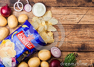 LONDON, UK - APRIL 15, 2019: Pack of Estrella crispy potato crisps chips with sour cream and onion on wooden table background Editorial Stock Photo