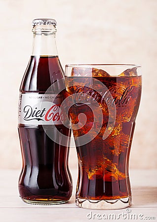 LONDON, UK - AUGUST 03, 2018: Glass bottle and original glass of Diet Coke Coca Cola soft drink on wooden background. Most popular Editorial Stock Photo