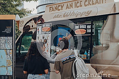 People getting ice-cream from Mr. Whippy van by Tower Bridge, London, UK Editorial Stock Photo