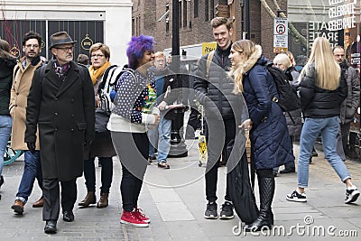 Young people talking to each other on the street. Girl with blue hair Editorial Stock Photo