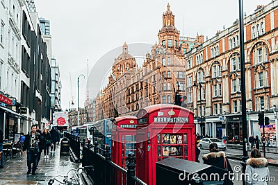 London, UK/Europe; 21/12/2019: Two red telephone booths next to the famous Harrods luxury department store at Knightsbridge Editorial Stock Photo