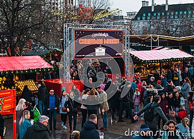 London, UK/Europe; 21/12/2019: Winter Christmas market in Southbank, London. People eating, drinking and having fun with friends Editorial Stock Photo