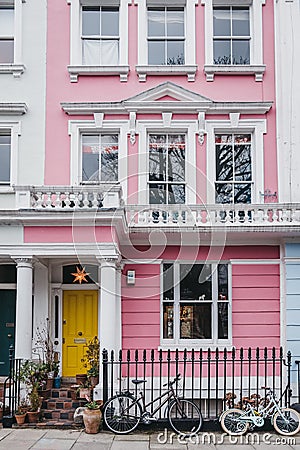 Bicycles by pastel pink coloured terraced house in Primrose Hill, London, UK Editorial Stock Photo