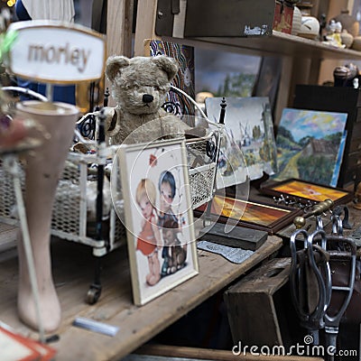 Spitalfields Antic Market. Display. Vintage teddy bear among antique items Editorial Stock Photo