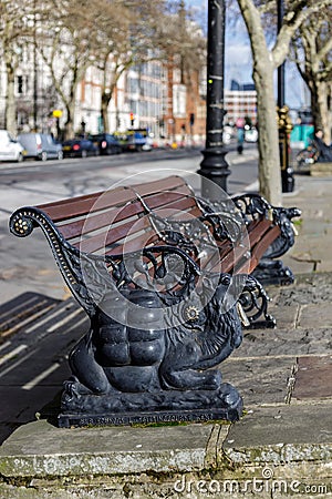 Camel design wooden bench on Victoria embankment in London on March 11, 2019 Editorial Stock Photo