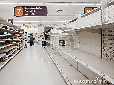 Empty shelves in canned goods and toiler paper aisle of Sainsburys supermarket in Golders Green, London, UK. Editorial Stock Photo
