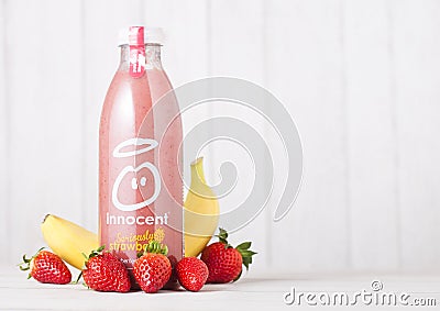 LONDON, UK - MAY 03, 2018: Bottle of Innocent strawberry and banana smoothie fruit drink with vitamins on wooden background. Editorial Stock Photo