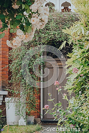 Plants and arch outside front door of a house in Palmers Green, London, UK, selective focus Editorial Stock Photo