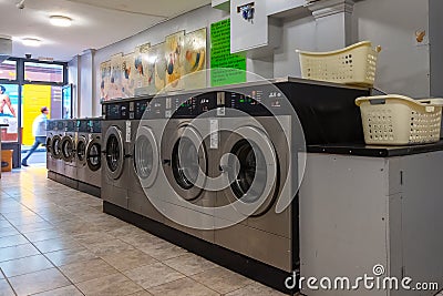 Coin laundries and cloth dryers in a self-service launderlette Editorial Stock Photo