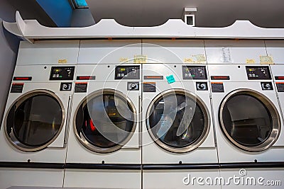 Coin laundries and cloth dryers in a self-service launderlette Editorial Stock Photo