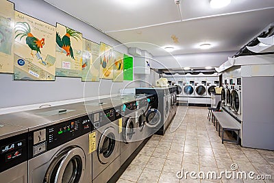 Row of coin laundries and cloth dryers Editorial Stock Photo