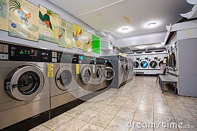 Row of coin laundries and cloth dryers Editorial Stock Photo