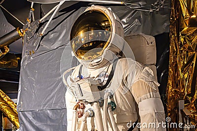 Space suit of Buzz Aldrin, born as Edwin Eugene Aldrin, exhibited next to a Full-sized replica of Eagle Editorial Stock Photo