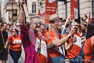 National AIDS trust with flags and banners celebrating London LGBTQ Pride Parade Editorial Stock Photo