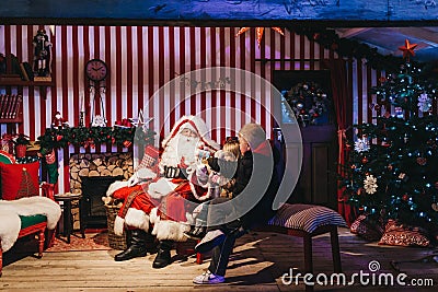 Children meeting Santa Claus at Winter Wonderland Christmas Fair, London, UK Editorial Stock Photo