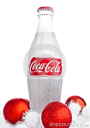 LONDON, UK - NOVEMBER 07, 2016: Classic bottle Of Coca-Cola on white background with christmas toys and snow Editorial Stock Photo