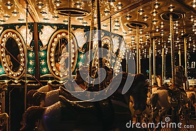 Close up of illuminated merry-go-round at Winter Wonderland Christmas Fair in London, UK. Editorial Stock Photo
