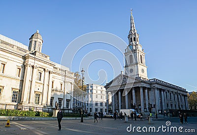 Pedestrians walk around historic St. Martin in the fields church Editorial Stock Photo