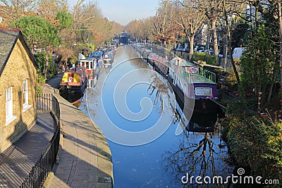 LONDON, UK: Reflections in Little Venice with colorful barges along canals Stock Photo