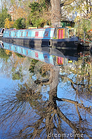 LONDON, UK: Reflections in Little Venice with colorful barges along canals Stock Photo