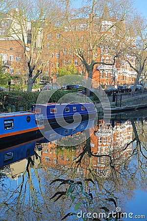 LONDON, UK: Reflections in Little Venice with colorful barges along canals Editorial Stock Photo