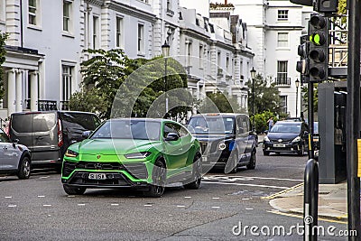 London, UK - September 14, 2023: Green Lamborghini Urus with green traffic light in central London Editorial Stock Photo