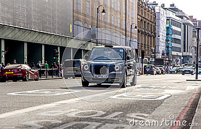 London, UK - September 14, 2023: New and improved electric Classic black British cab taxi Editorial Stock Photo